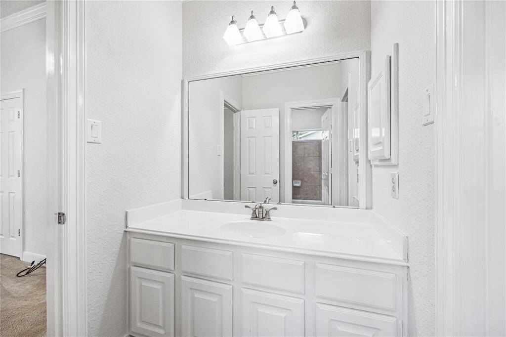 Secondary bathroom with a clean, functional vanity.