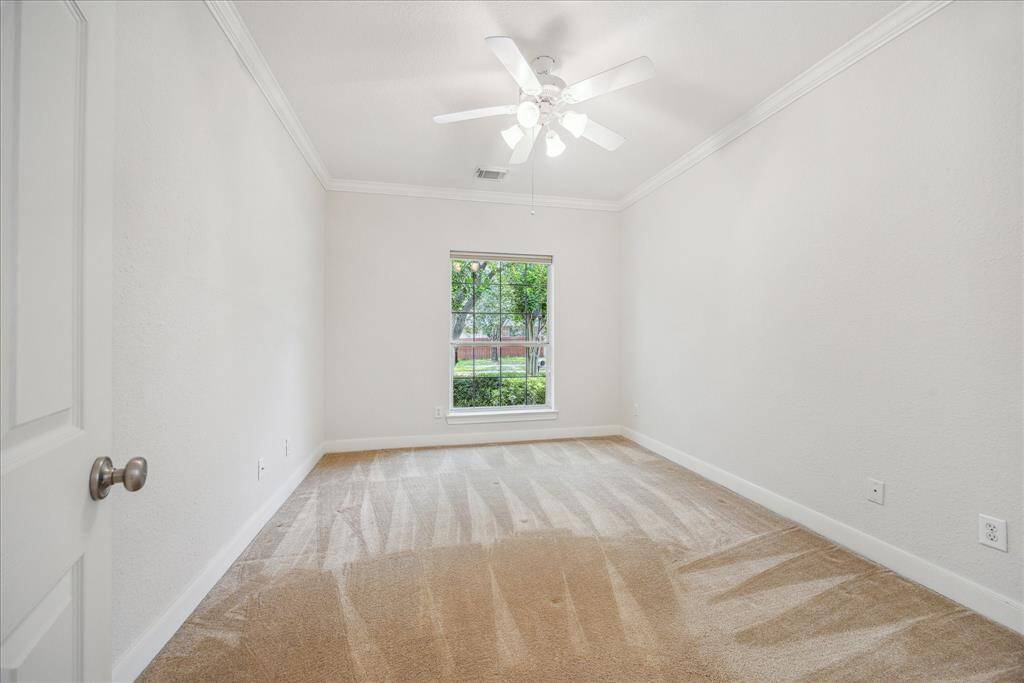 One of the secondary bedrooms is located near the front of the home and features a window overlooking the front yard.