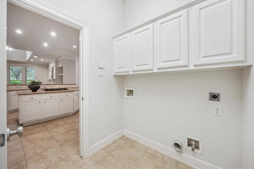 Spacious utility room conveniently located just off the kitchen.