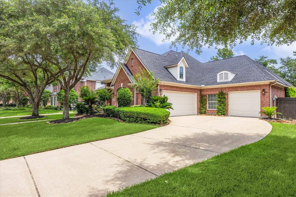 Three-car garage with a wide driveway, providing plenty of parking space for residents and guests.