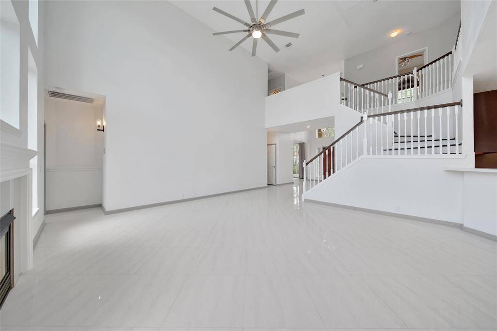 In addition to the sprawling main level living area, there is a secondary living room/game room upstairs, truly offering space for everyone! The primary suite is located on the main floor and is tucked away at the back of the home down a small hallway for privacy and noise reduction.