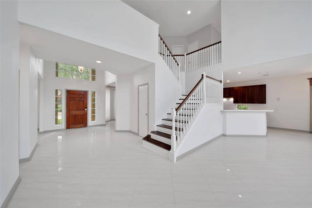 The foyer of the home is the central hub, with a formal dining to one side, a study to the other, a large under stairs closet, and a half bath for guests, all before entering the impressive two story living room.