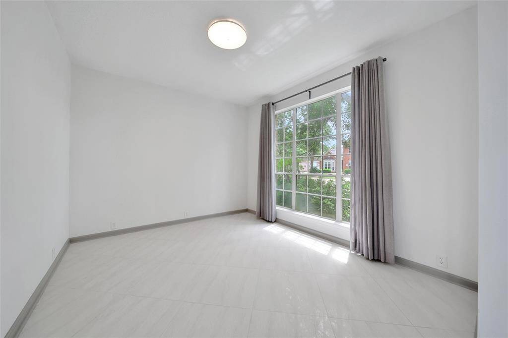The front study/flex room is located off the foyer and features beautiful views of the front yard.