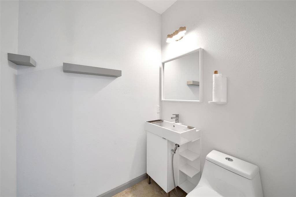 The half bath for guests is conveniently located at the front of the home between the formals and the living room.
