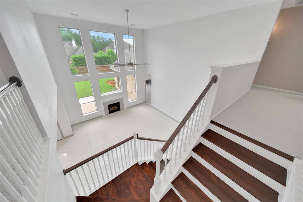 The staircase impresses with hardwood treads lining the way to the second floor where three bedrooms, two full bathrooms and a game room await.