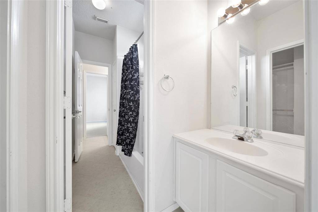 The front bedroom offers a Jack and Jill bath with its own vanity and a shared tub/shower combination.