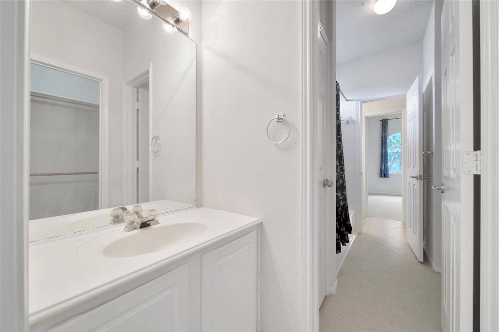 The back bedroom has its own vanity area and walk-in closet in the Jack and Jill bathroom set up.