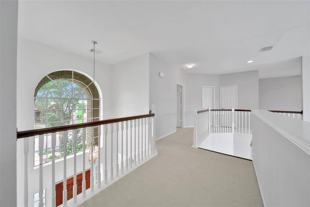 The upstairs layout is a split-plan with two bedrooms sharing a Jack and Jill bath on one side and a guest suite and a game room on the other side.