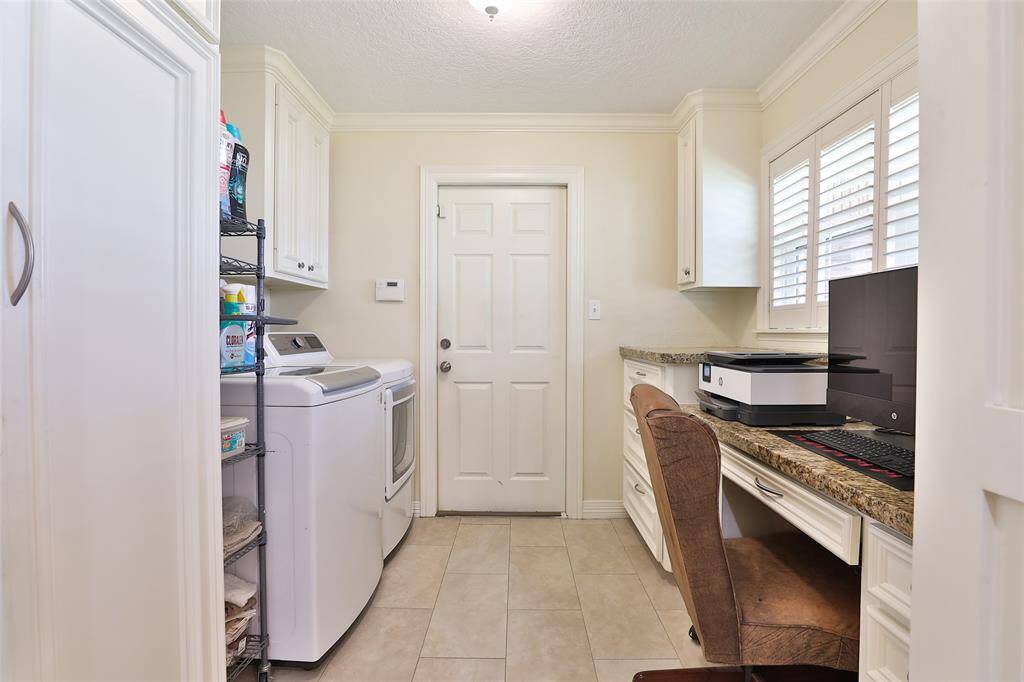 Great laundry room which features your pantry and an extra desk with plenty of storage.  Washer and dryer is excluded from sale of the house.