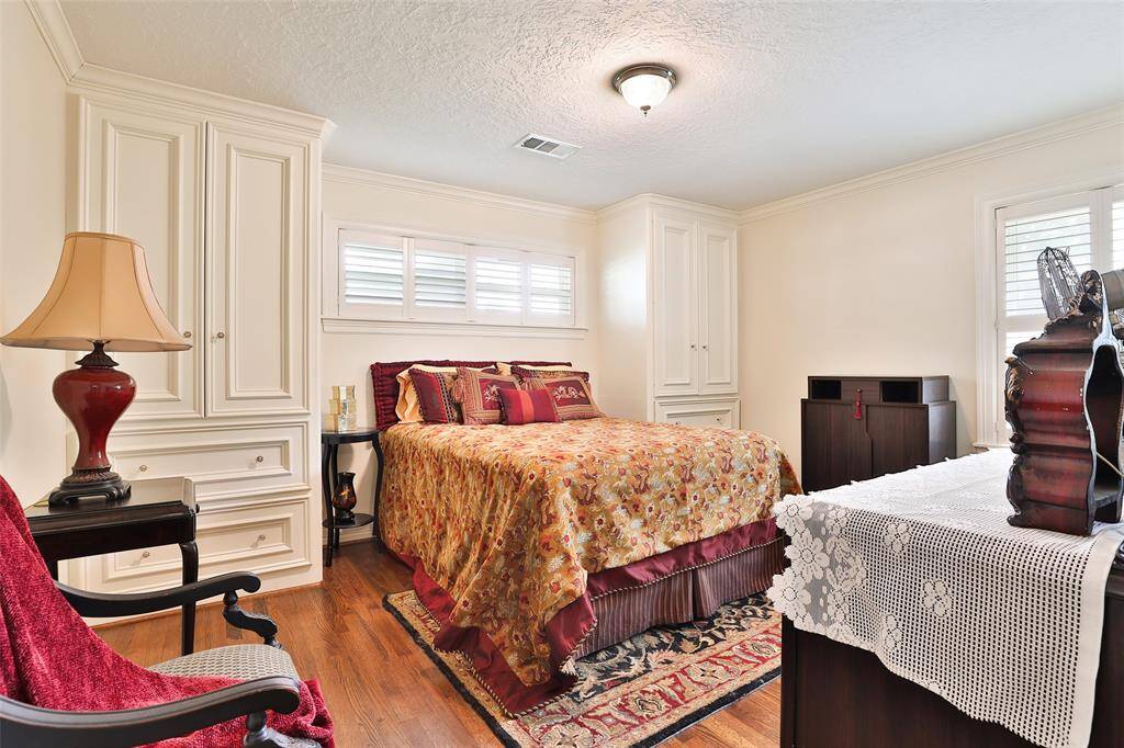 This front bedroom features 2 armoires with deep drawers for extra storage, 2" wood shutters on the windows and beautiful red oak hadwood flooring!