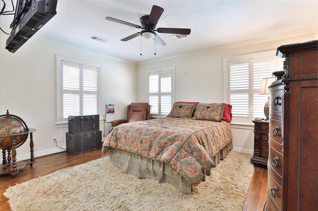 This is your back bedroom and also the primary bedroom. Again the red oak hardwood floors, 2" wood blinds on the windows and ceiling fan!  Walk in closet in this bedroom!