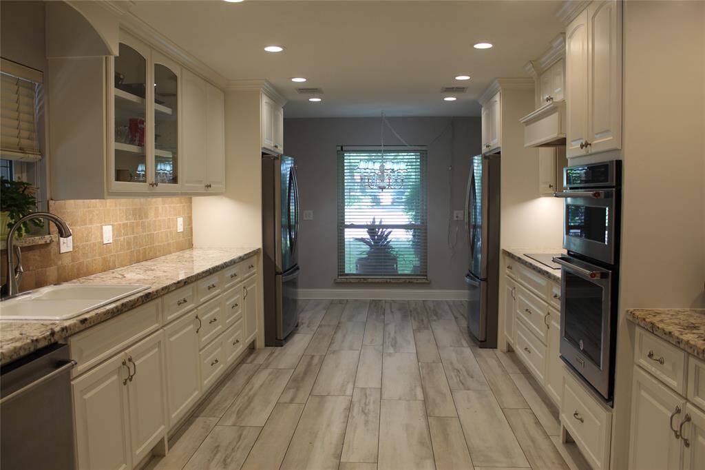 Galley kitchen with granite countertops and custom cabinets, and soft close drawers