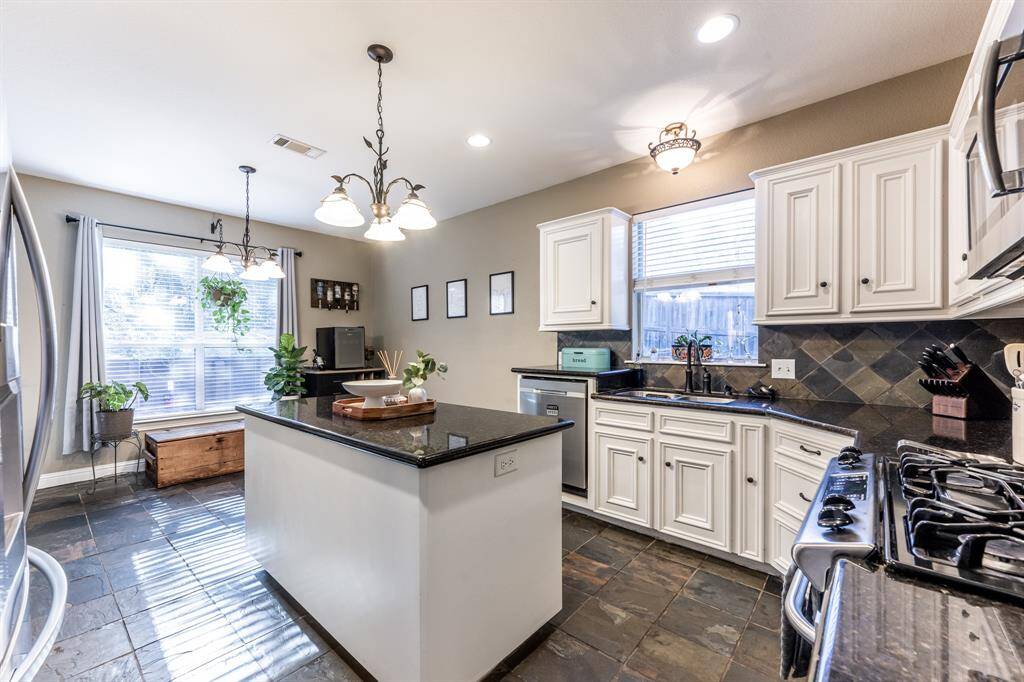 Hello, heart of the home! With stylish white cabinets, granite countertops, stainless appliances, and a center island made for snacks, chats, or showing off your latest recipe—you’ll actually want to cook here (or at least pretend you do).