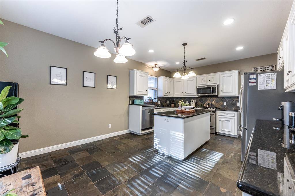Plenty of space to chop, stir, sip, and socialize—this kitchen’s got the flow and the function. Bonus points for that island that doubles as a prep zone and the perfect perch for kitchen convos.