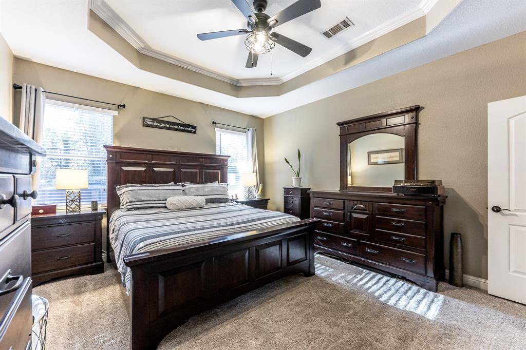 Plenty of space, serious ceiling style, and sunlight that hits just right—this primary suite is made for recharging, relaxing, and hitting snooze at least once.