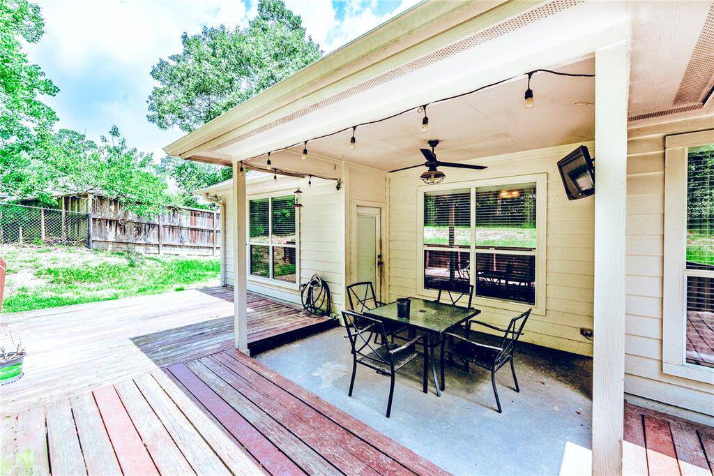 Covered, spacious, and ready to entertain—this backyard hangout has room for grilling, chilling, and soaking up the good life (string lights and ceiling fan included).