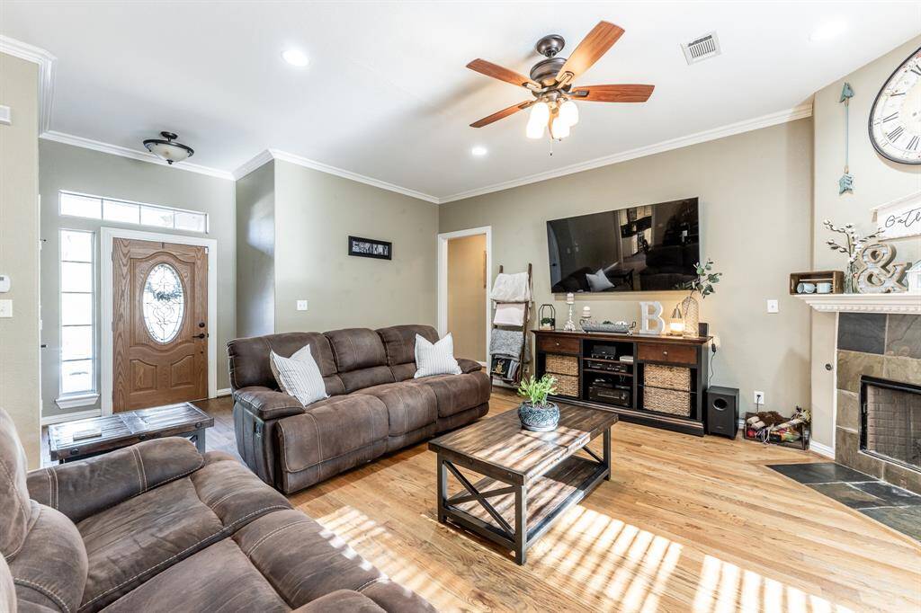 From the moment you walk in, it just feels like home—real hardwood floors, high ceilings, and a cozy fireplace set the stage for everyday comfort and laid-back living.
