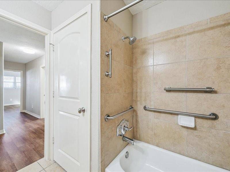 The guest bath is conveniently located and offers ample storage.