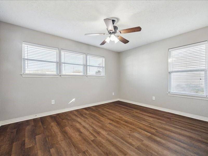 The generously sized third extra bedroom features large windows that fill the space with abundant natural light.