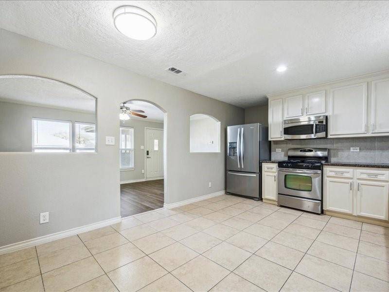 Natural light stream through well-placed windows, enhancing the home's warm and airy ambiance.