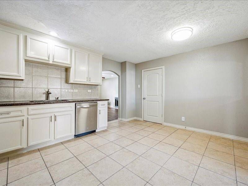 The open concept kitchen seamlessly connects both living areas, fostering a natural flow throughout the home.