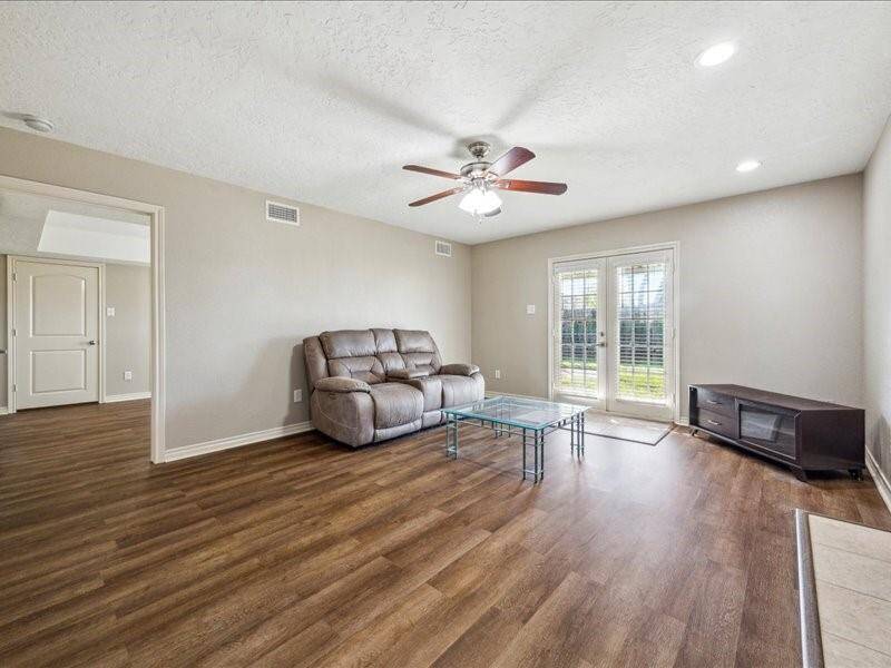 The second living space, situated at the back of the home near the kitchen, offers extra room and direct access to the primary bedroom.
