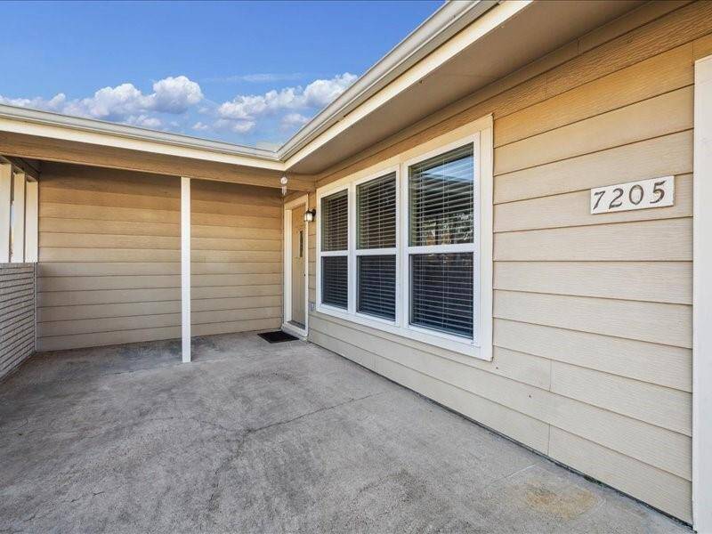 The spacious and private front porch features a covered entry and is perfect for outdoor seating.