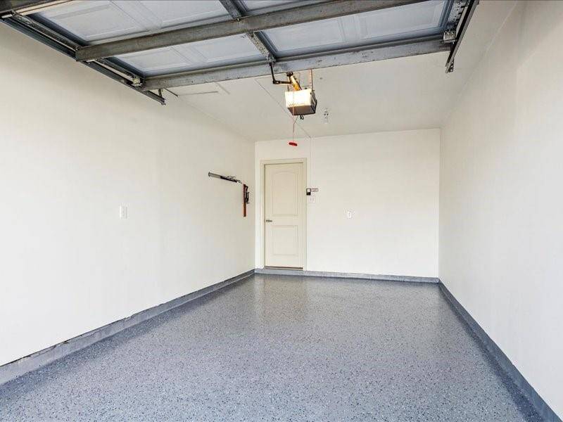 The garage, featuring durable poly flooring, adds an extra layer of practicality and style.
