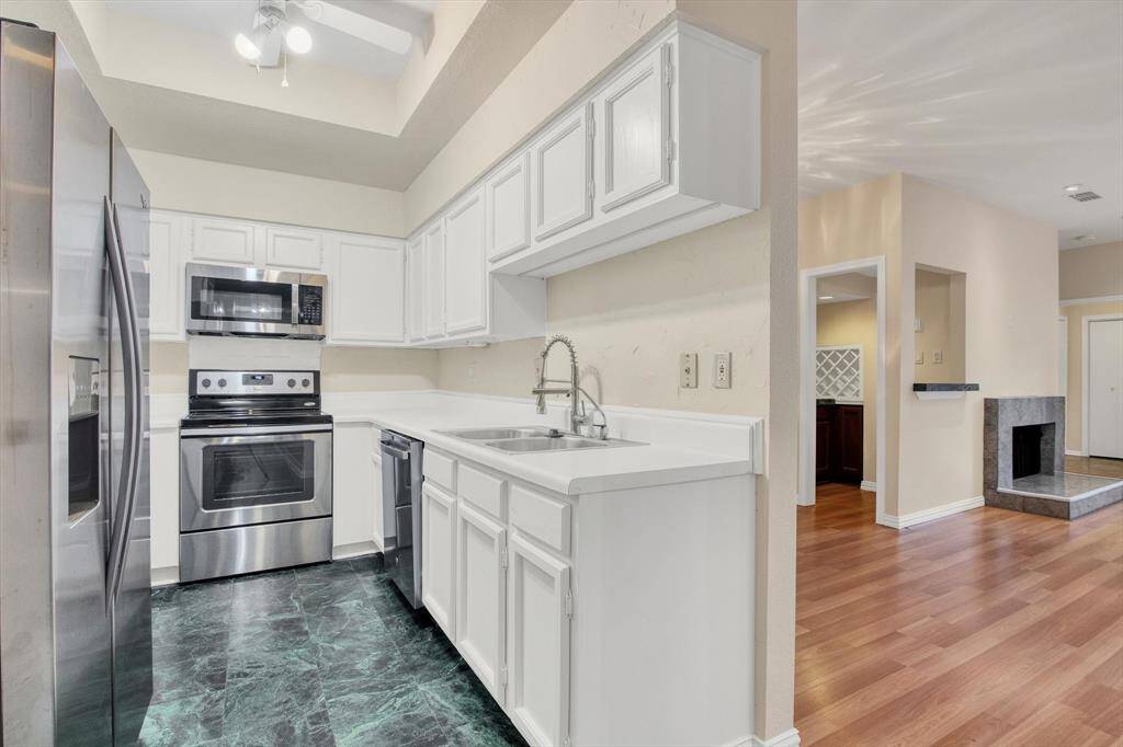 Freshly painted kitchen with updated stove and faucet
