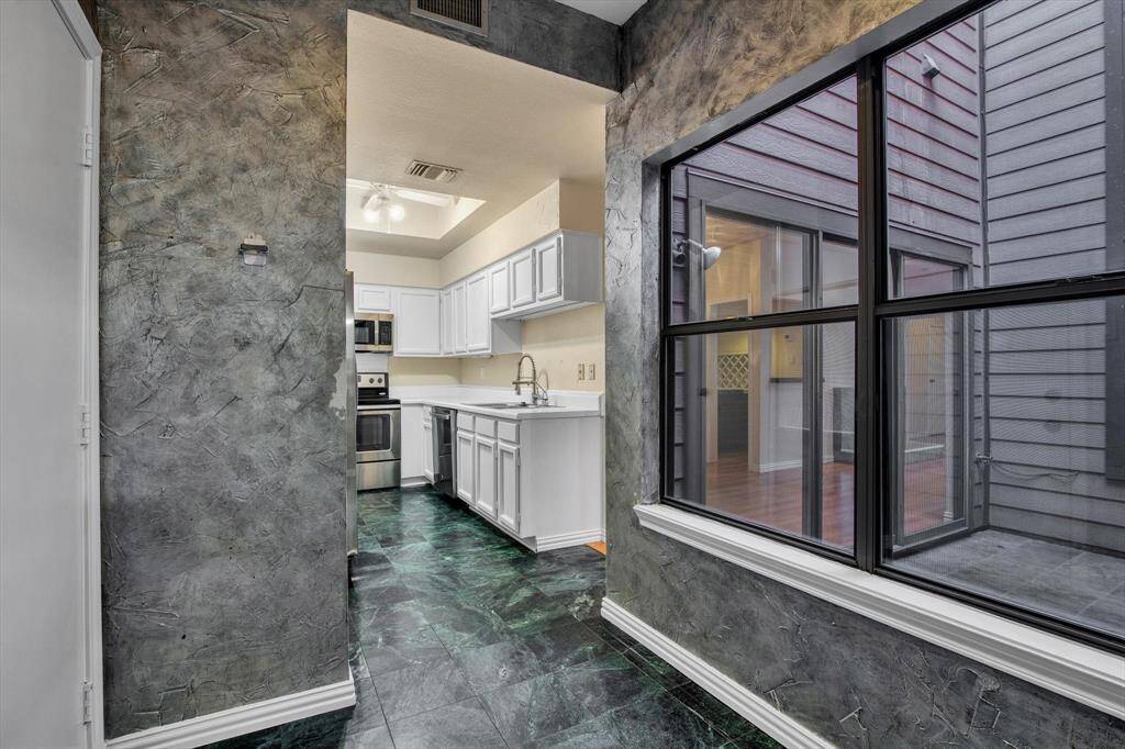 From breakfast nook towards the kitchen with atrium to the right