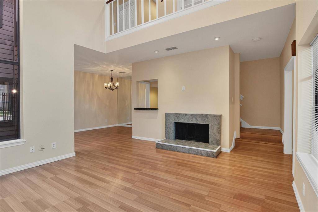 Lots of light in living room with marble fireplace