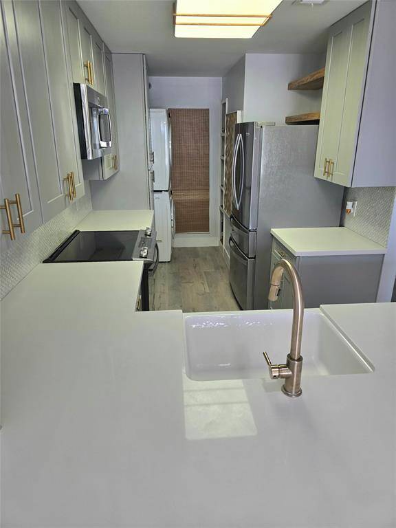 Sleek hardware, contemporary colors, and clean lines enhance the cabinetry, creating a fresh, modern look throughout the space.