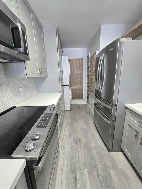 Upgraded soft-close cabinets with sleek modern pulls are just one of the many premium features that elevate the style and functionality of Unit 409.