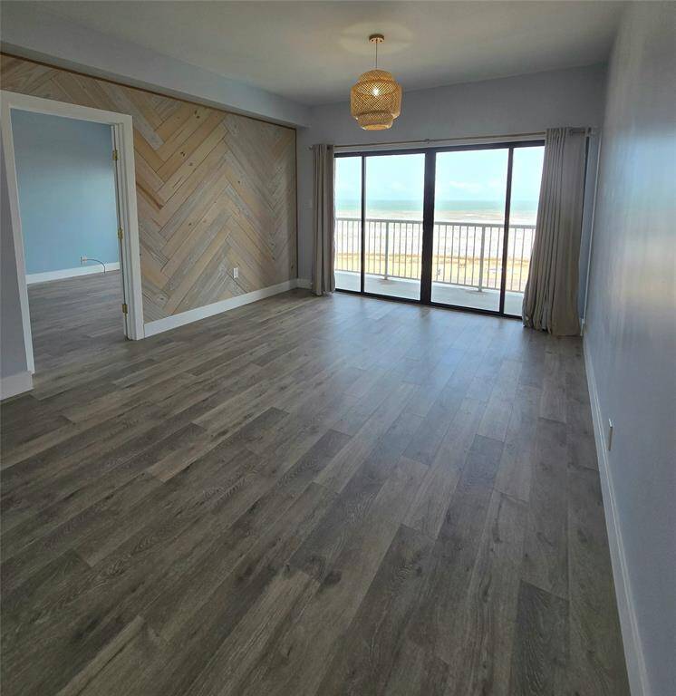 view from kitchen toward balcony.  This unit is light a bright with natural light.  Unit is updated with deluxe vinyl-plank floors.