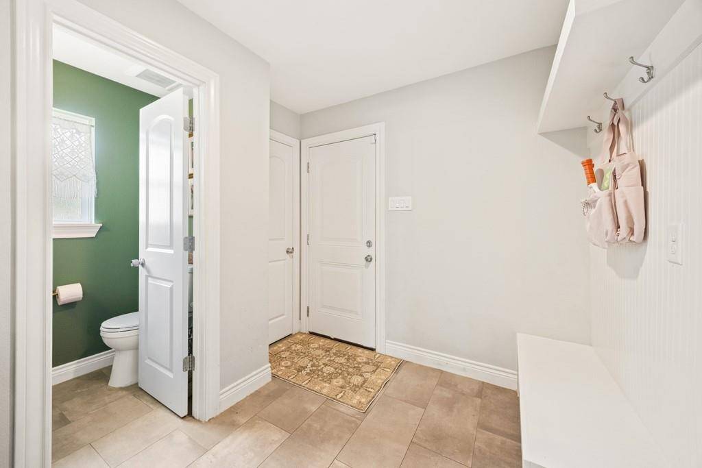 Half bath/mud room off the kitchen- leading to the garage.
