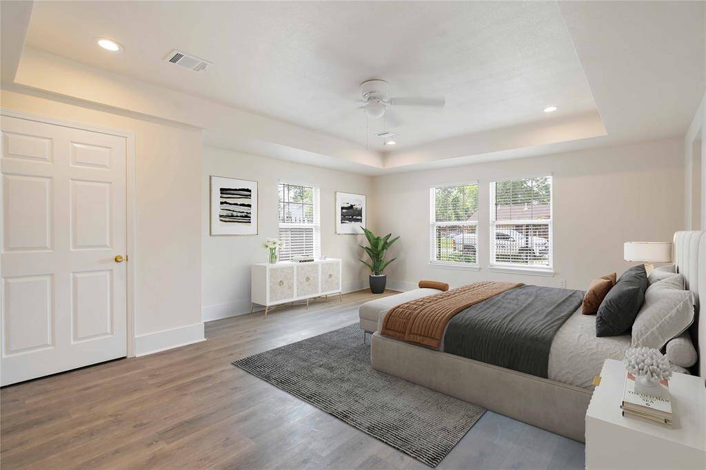 Spacious and beautifully staged primary suite featuring abundant natural light and modern finishes, creating a serene retreat.