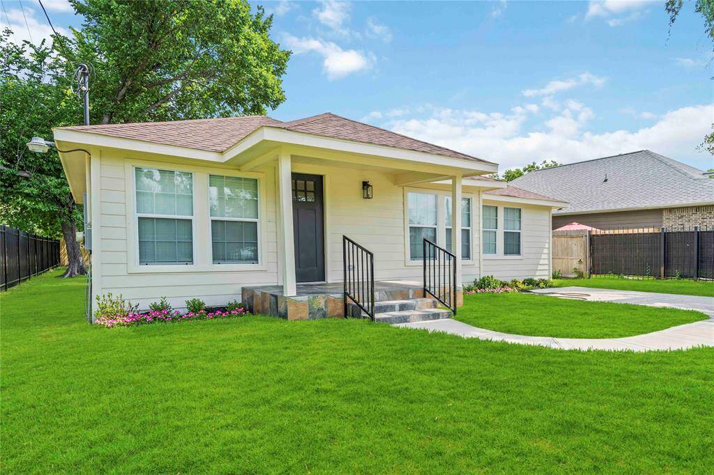 Charming single-story home with a welcoming front porch, large windows, and a well-maintained lawn. Perfect for enjoying outdoor activities and easy living.