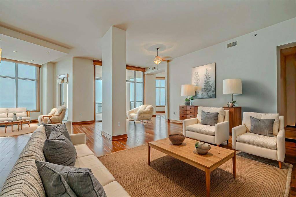 Spacious family room on the 28th floor penthouse featuring handcrafted wood floors and custom designs—perfect for entertaining!(AI photo)