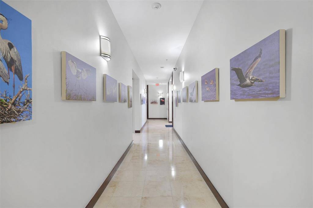 Experience breathtaking elegance on the 28th floor with travertine hallways adorned with exquisite bird art.