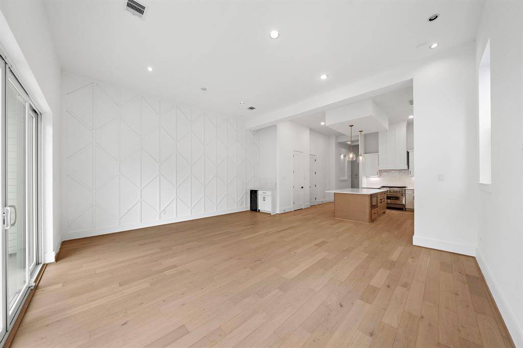 Alternate view of living/dining room with 12' ceilings, light & bright throughout. (Photo is of a previously completed home.)