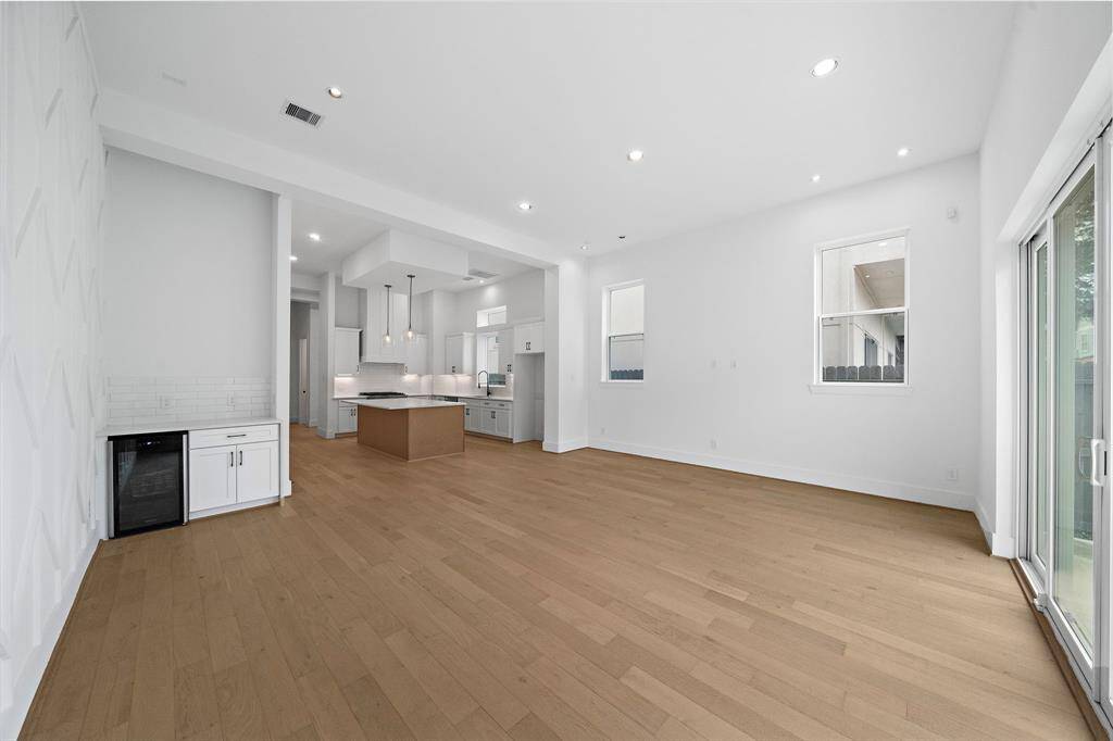 Living/dining room also features a convenient bar area with wine cooler and additional storage! (Photo is of a previously completed home.)