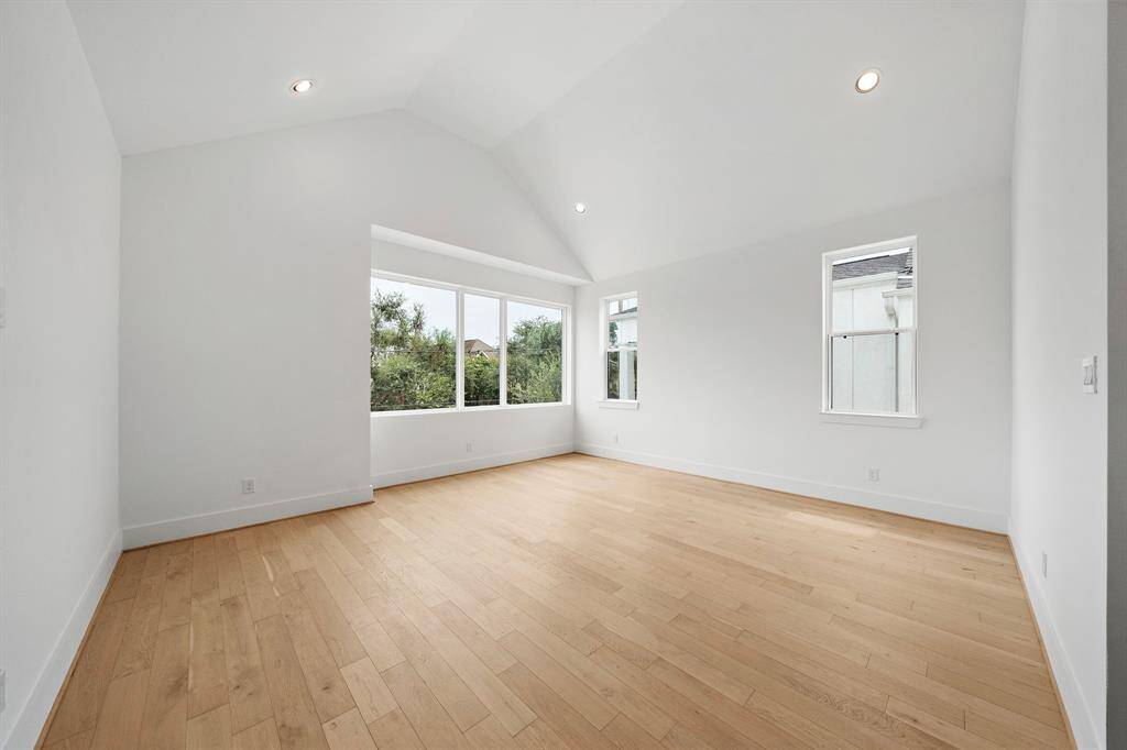 Impressive primary bedroom features a unique cathedral ceiling and amazing oversized windows. (Photo is of a previously completed home.)