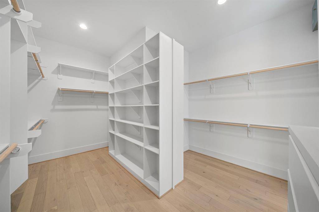 HUGE walk-in closet with built-ins and plenty of space to keep organized. This is one of two master closets. (Photo is of a previously completed home.)