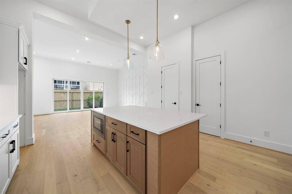 Alternate view of the gorgeous island kitchen with impressive finishes. (Photo is of a previously completed home.)