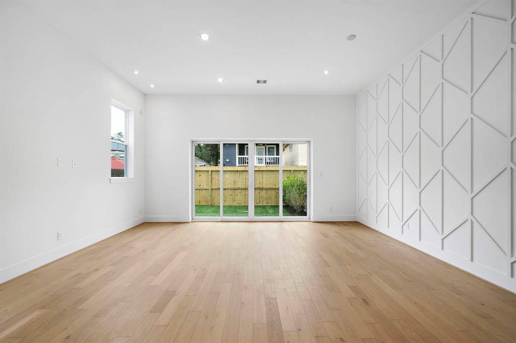 Living/dining area with 12-foot ceilings, great natural light, and an oversized backyard, perfect for entertaining. (Photo is of a previously completed home.)