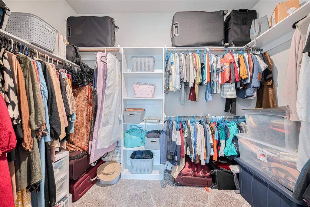 This spacious walk-in closet features ample space.