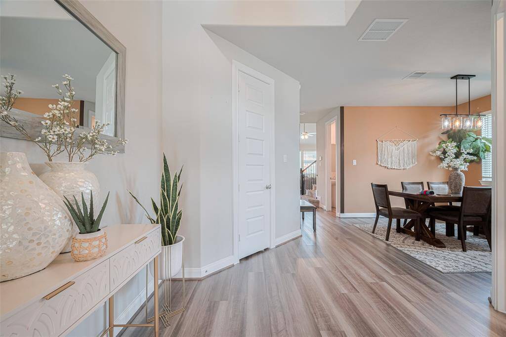 Bright and welcoming entryway leads into an open dining area.