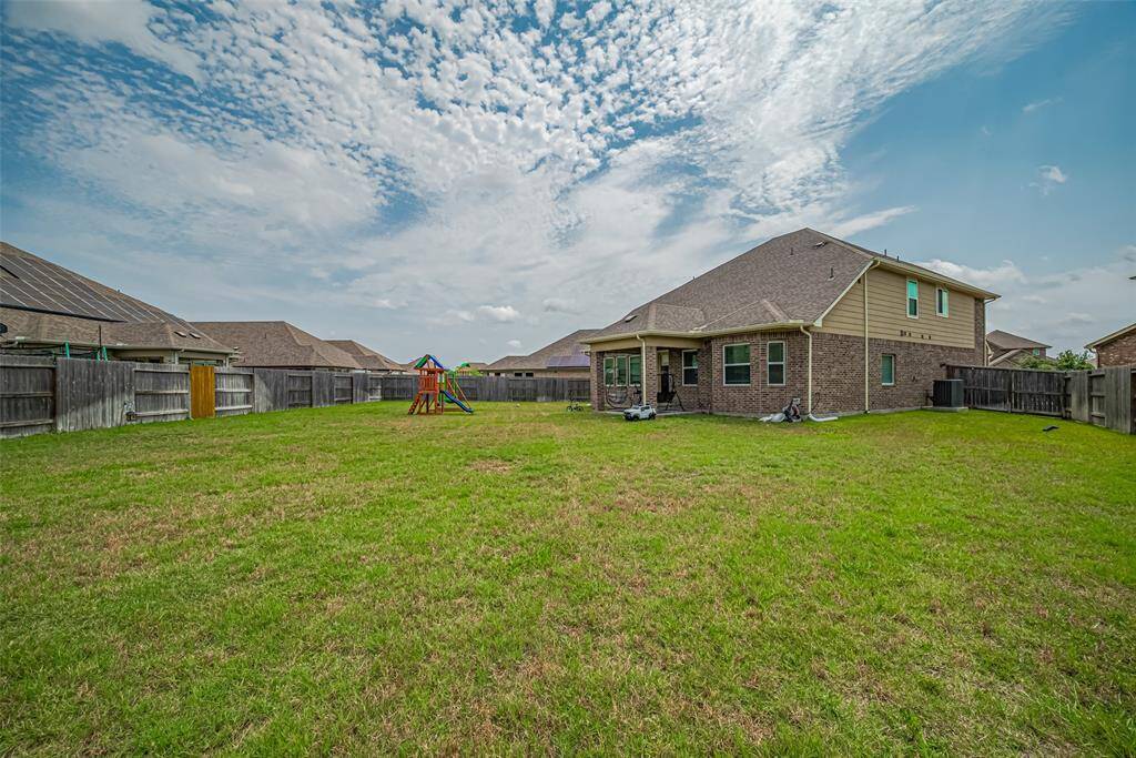 Spacious backyard offering privacy and safety for outdoor activities.