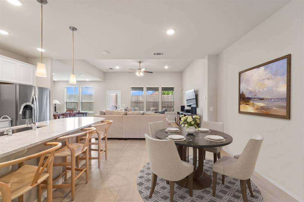 Thoughtfully designed open-concept layout with informal dining, oversized island seating, and seamless flow into the spacious living area—perfect for gatherings or daily life.