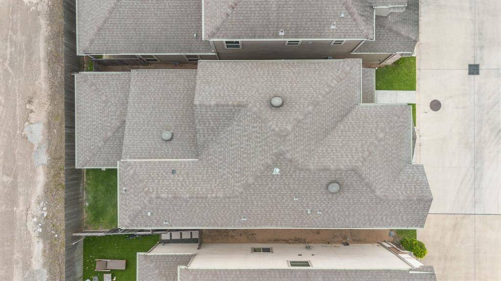 Aerial view of the home’s roofline and lot placement—tucked within a secure, gated community with manicured streets and green spaces.